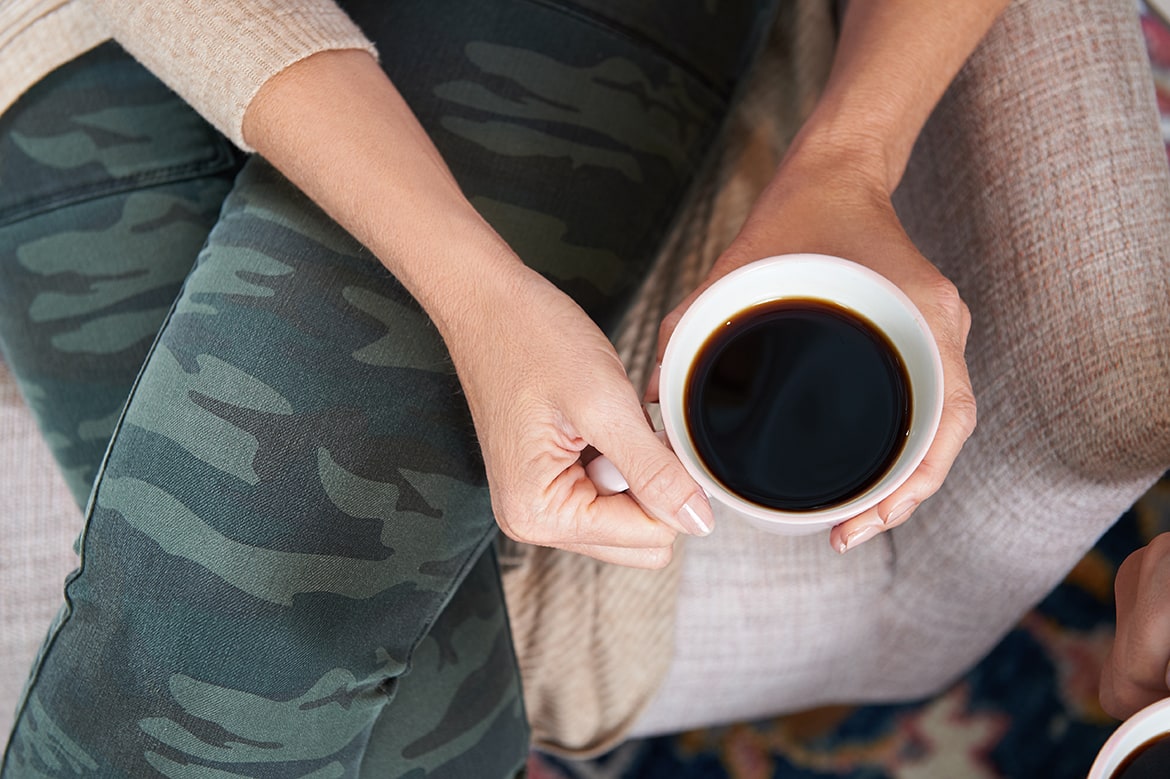 Camo Hudson Jeans and coffee cup